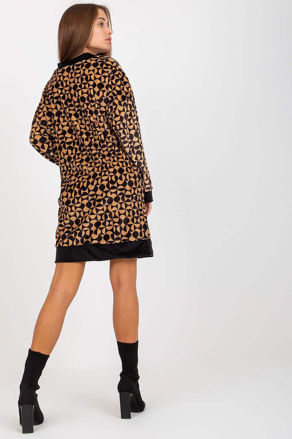 Back view of a luxurious short velour dress showcasing a sophisticated geometric pattern, designed for everyday elegance, paired with stylish black ankle boots.