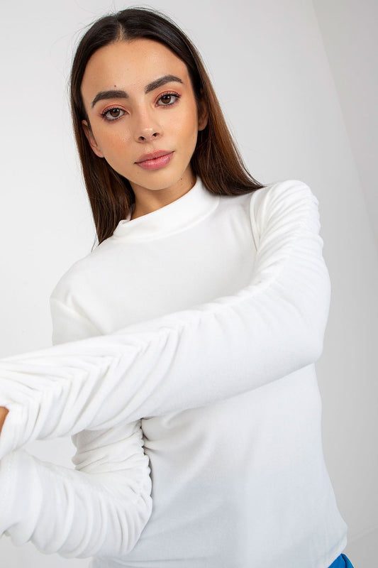 Close-up of a fashionable white velour blouse featuring dramatic ruched long sleeves and a refined stand-up collar, highlighted against an elegant background.
