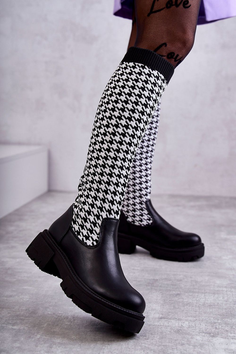 Elegant women's thigh-high boots in eco leather with a stylish houndstooth patterned fabric. Features a flattering flat heel and premium insulated design, perfect for chic winter outings.
