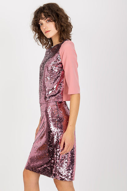 Elegant Lakerta blouse featuring sequins and elbow-length sleeves, styled with a chic pink skirt, exuding sophistication and glamour.