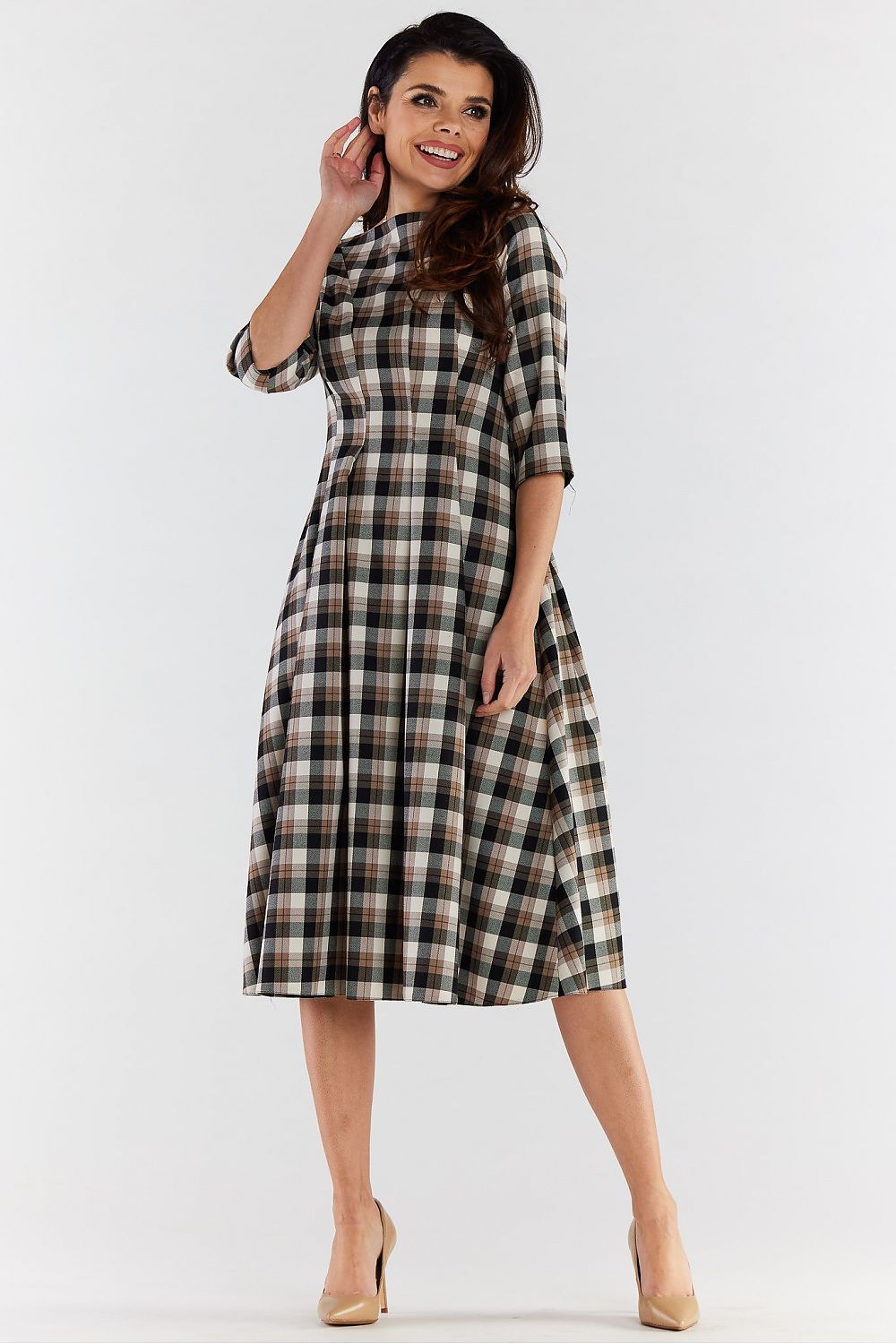 Elegant woman showcasing a chic 3/4 sleeve midi dress in a sophisticated checkered pattern, complete with a flared design, exuding timeless style and refinement.