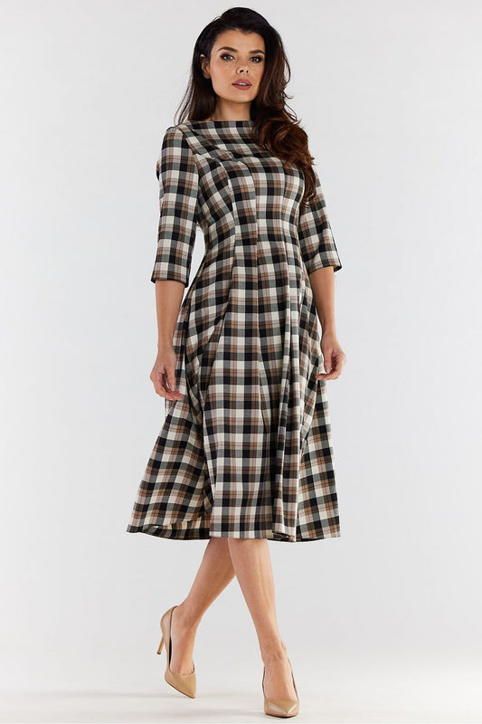 Close-up view of a graceful woman wearing a stylish checkered midi dress with flared sleeves, highlighting the dress's flattering cut and luxurious fabric.