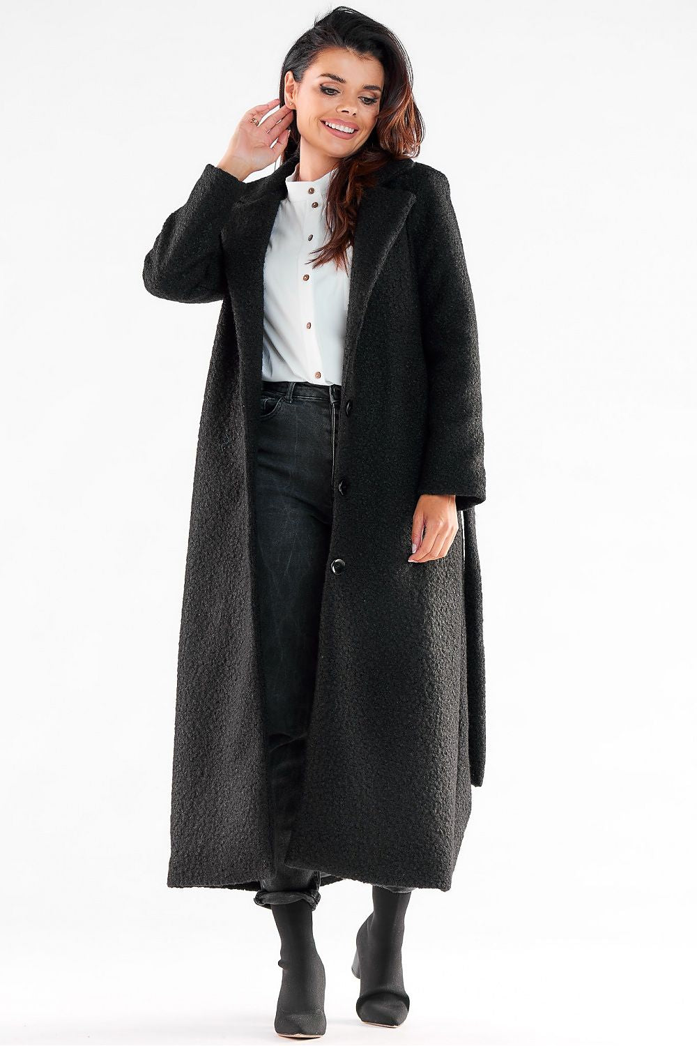 Chic black maxi coat by Awama, worn by a stylish lady, showcasing a tailored silhouette and versatile design ideal for both casual and formal occasions.