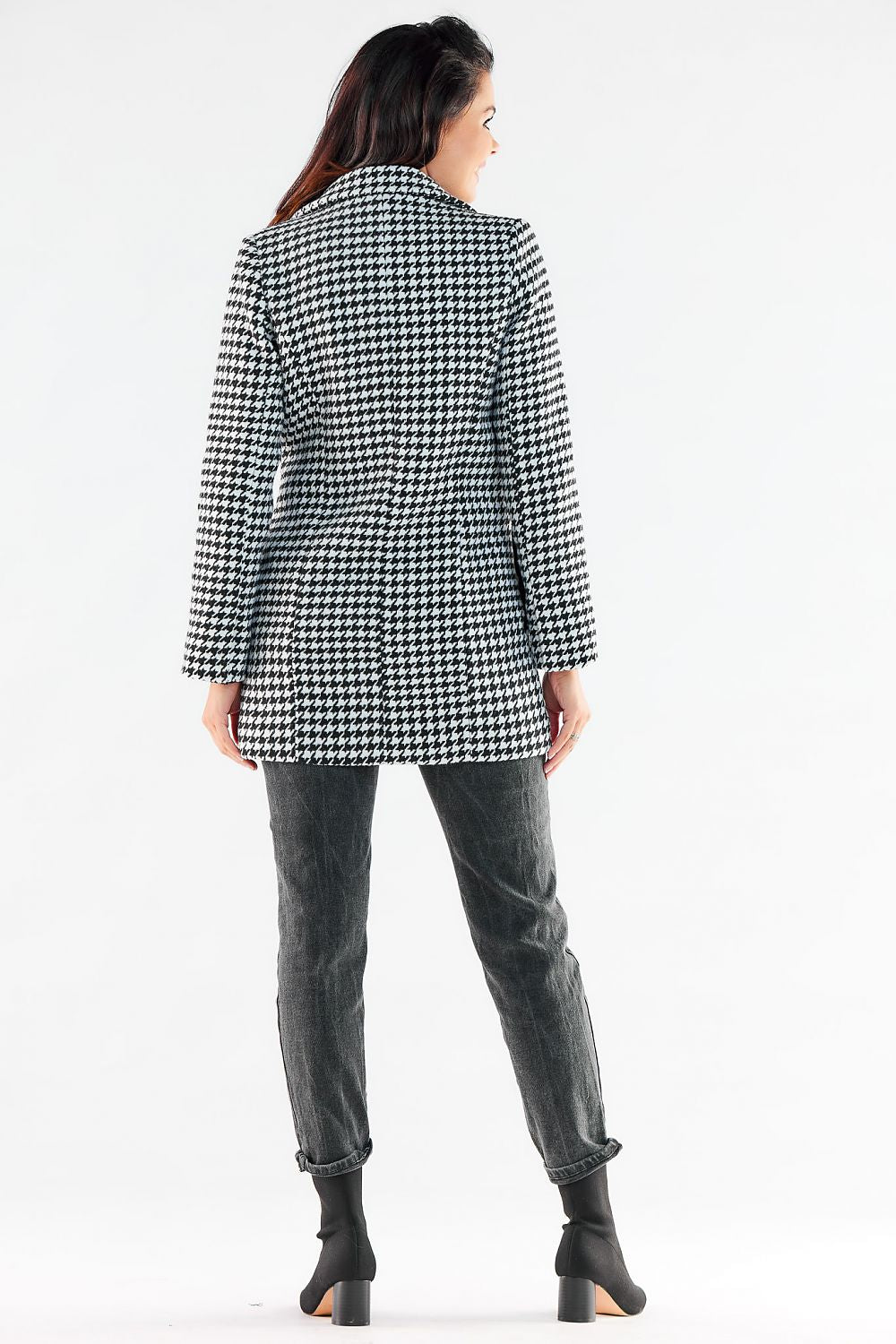 Elegant woman showcasing the back view of a stylish double-breasted coat with houndstooth pattern, perfect for sophisticated occasions.