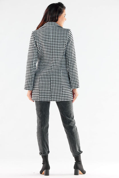 Elegant woman showcasing the back view of a stylish double-breasted coat with houndstooth pattern, perfect for sophisticated occasions.