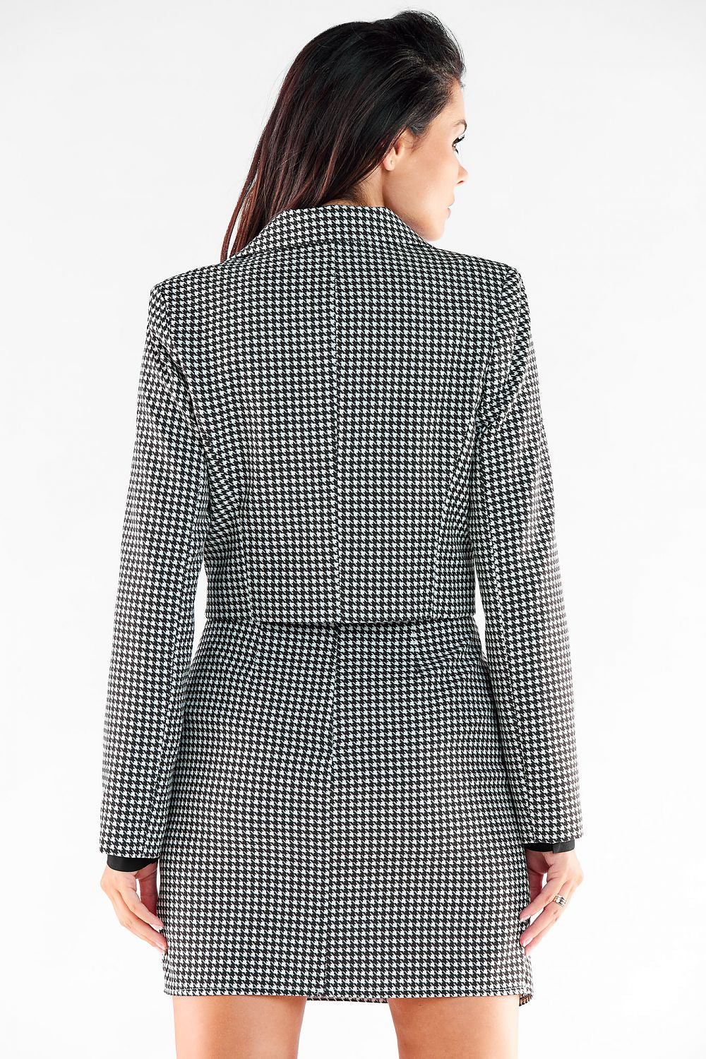 Back view of a luxurious Awama button jacket, highlighting its sophisticated tailored silhouette and graceful long sleeves.