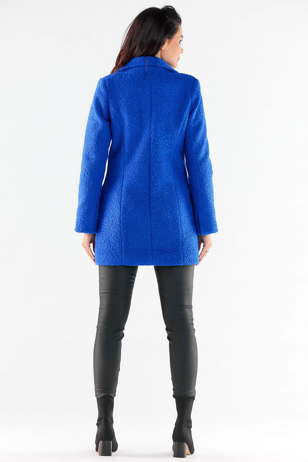 Stylish back view of a woman in a blue textured double-breasted coat, showcasing contemporary elegance and comfort.