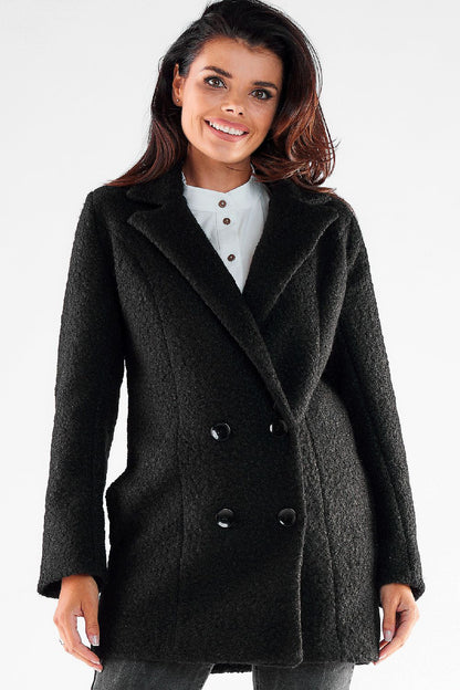 Elegant double-breasted Awama coat featuring large black buttons, showcased by a model with a bright smile, perfect for stylish winter outfits.