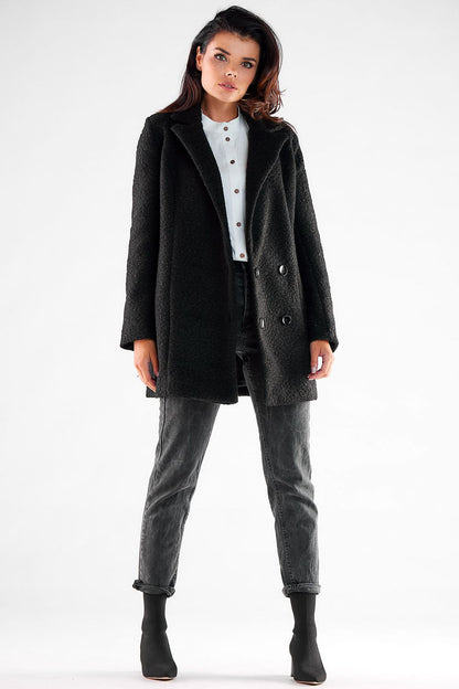 Front view of a sophisticated double-breasted Awama coat on a model, displaying its luxurious fabric and large black buttons, ideal for fashionable layering.