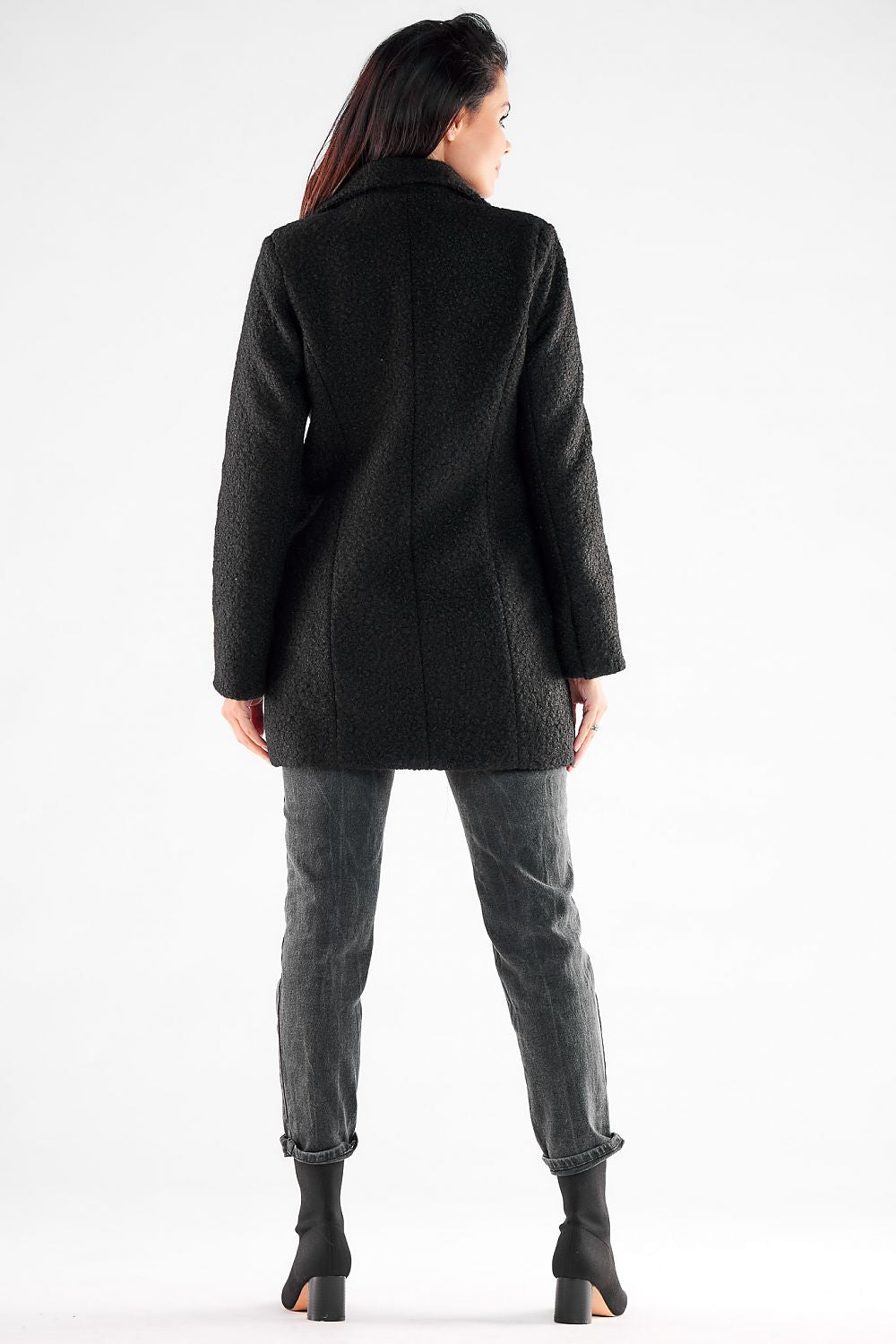 Back view of a chic Awama coat on a model, highlighting the elegant silhouette and luxurious texture, a perfect addition to any stylish wardrobe.