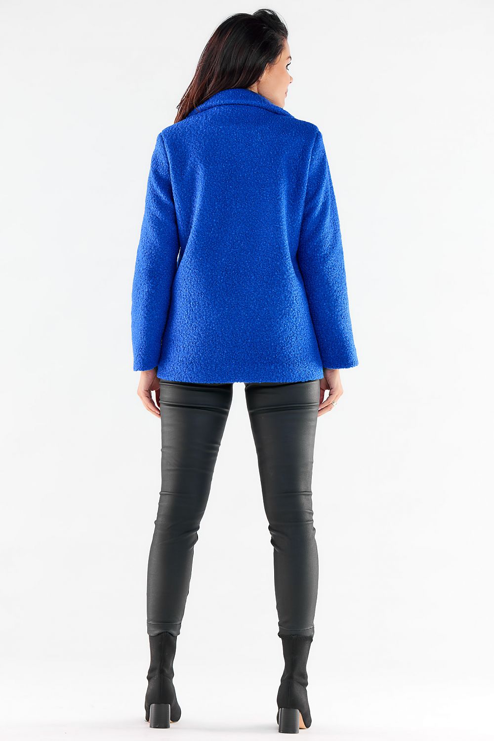 Sophisticated back view of a model in a luxurious blue jacket by Awama, perfectly styled with black leather trousers, exuding elegance.