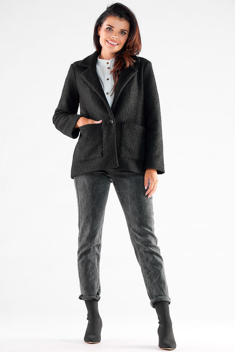 Elegant Awama Jacket in black, featuring square pockets and a stylish button, perfectly tailored for a sophisticated silhouette, showcased by a smiling model in casual chic attire.