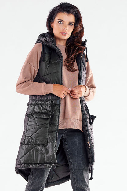 Luxurious black quilted hooded gilet by Awama, emphasizing elegant autumn wear, model featured in a stylish and functional outfit.