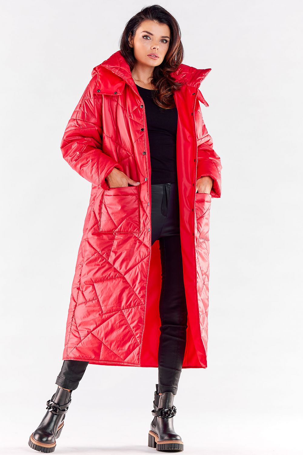 Chic long red quilted coat with a large hood, elegantly styled with deep pockets for a fashionable autumn and winter look.