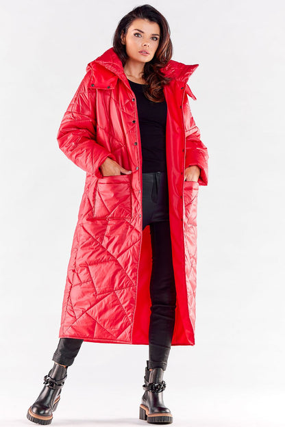 Chic long red quilted coat with a large hood, elegantly styled with deep pockets for a fashionable autumn and winter look.