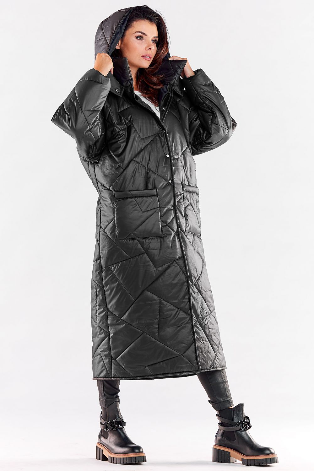 Fashion-forward black quilted coat with a voluminous hood, offering both style and comfort for the winter season.
