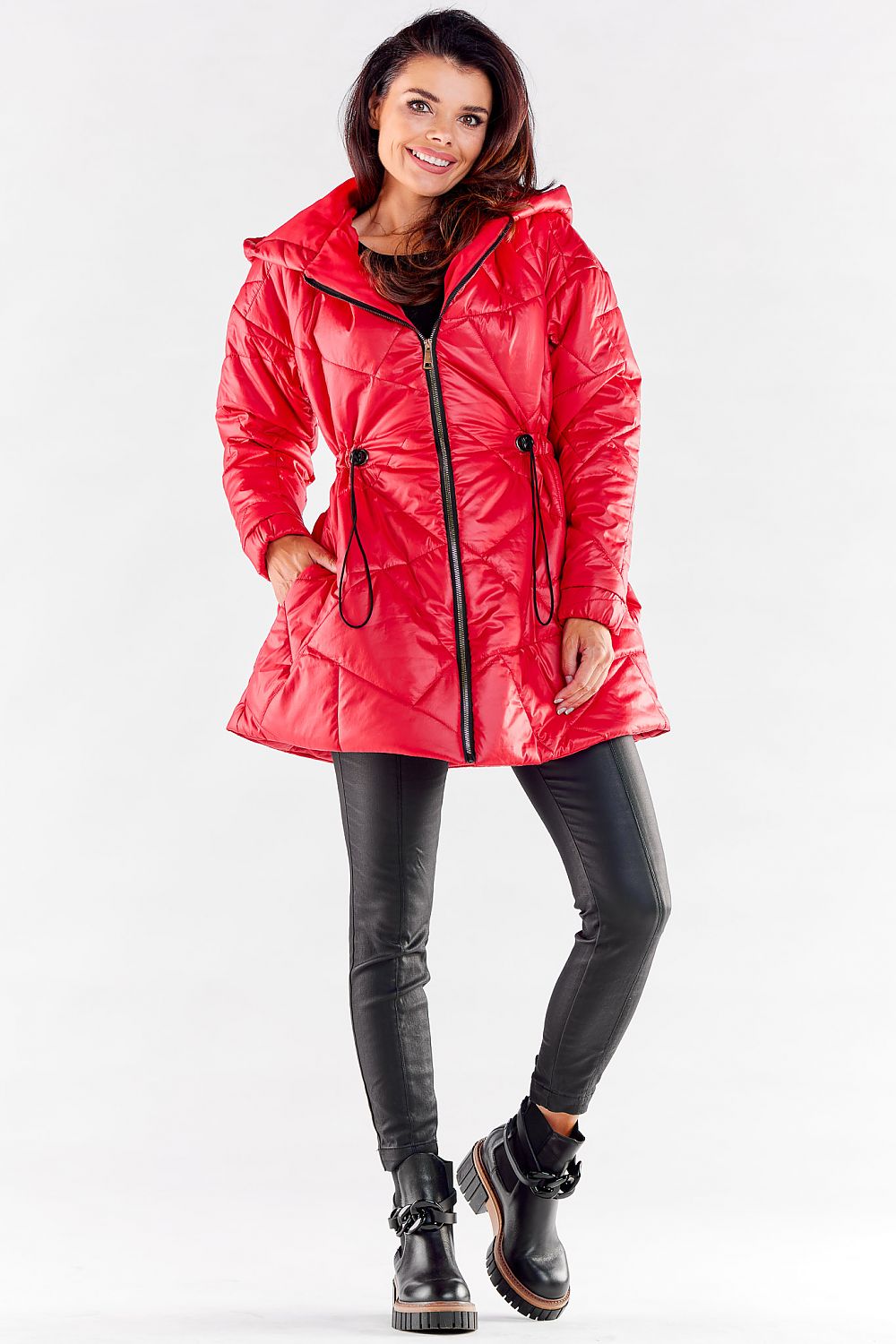 Charming female model in a luxury red quilted hooded jacket, featuring a flattering silhouette and functional waist adjustments, ideal for a fashionable and warm look.