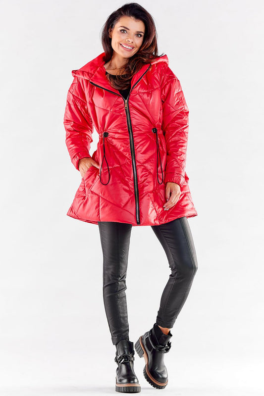 Charming female model in a luxury red quilted hooded jacket, featuring a flattering silhouette and functional waist adjustments, ideal for a fashionable and warm look.