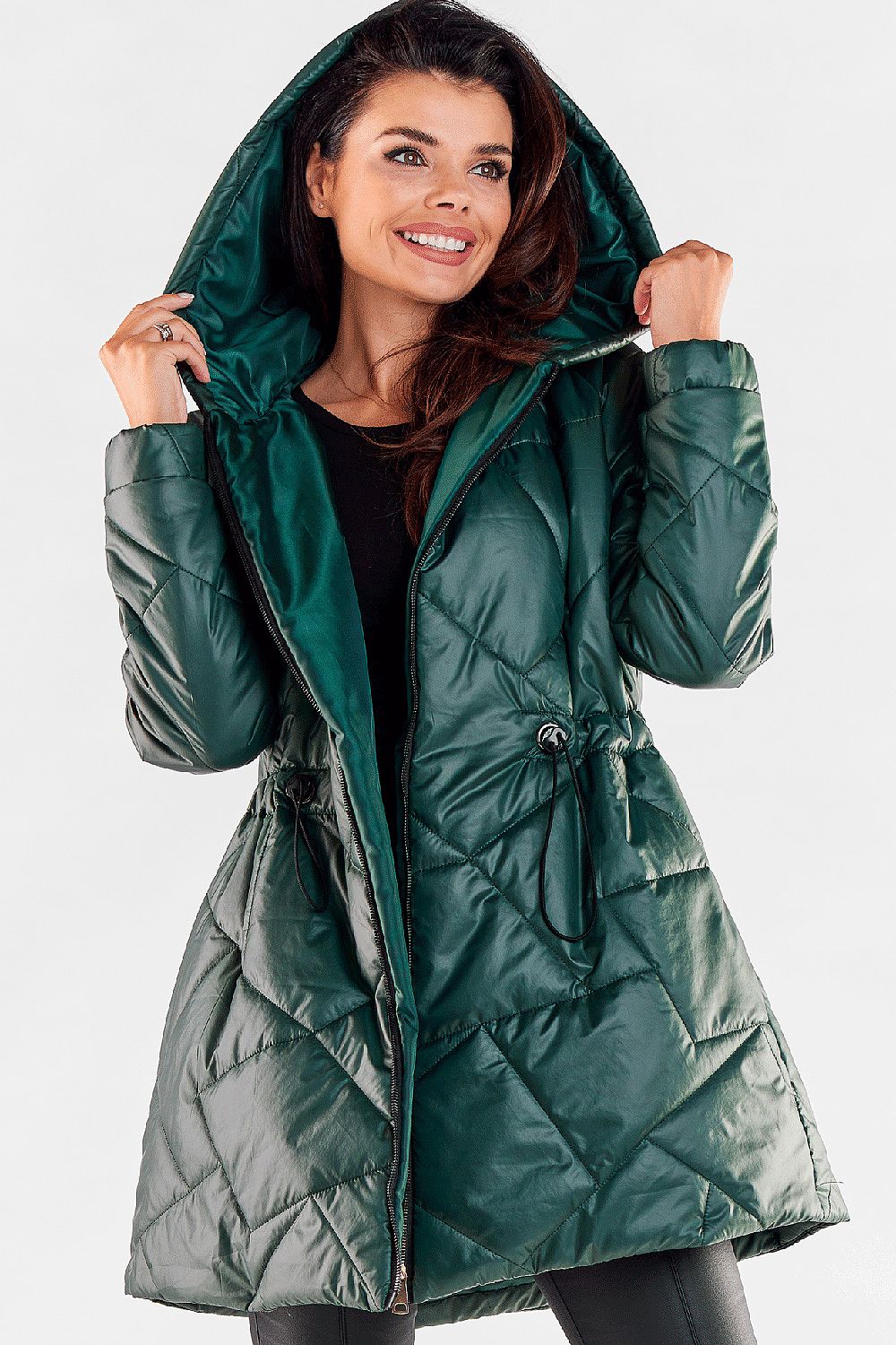 Fashion-forward woman showcasing a luxurious green quilted hooded jacket, with a contemporary design and adjustable features, perfect for upscale outings.
