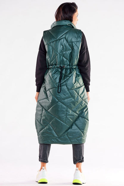 Refined green oversized vest shown from the back, highlighting the adjustable waist feature and luxurious fully lined quilted fabric for comfort.