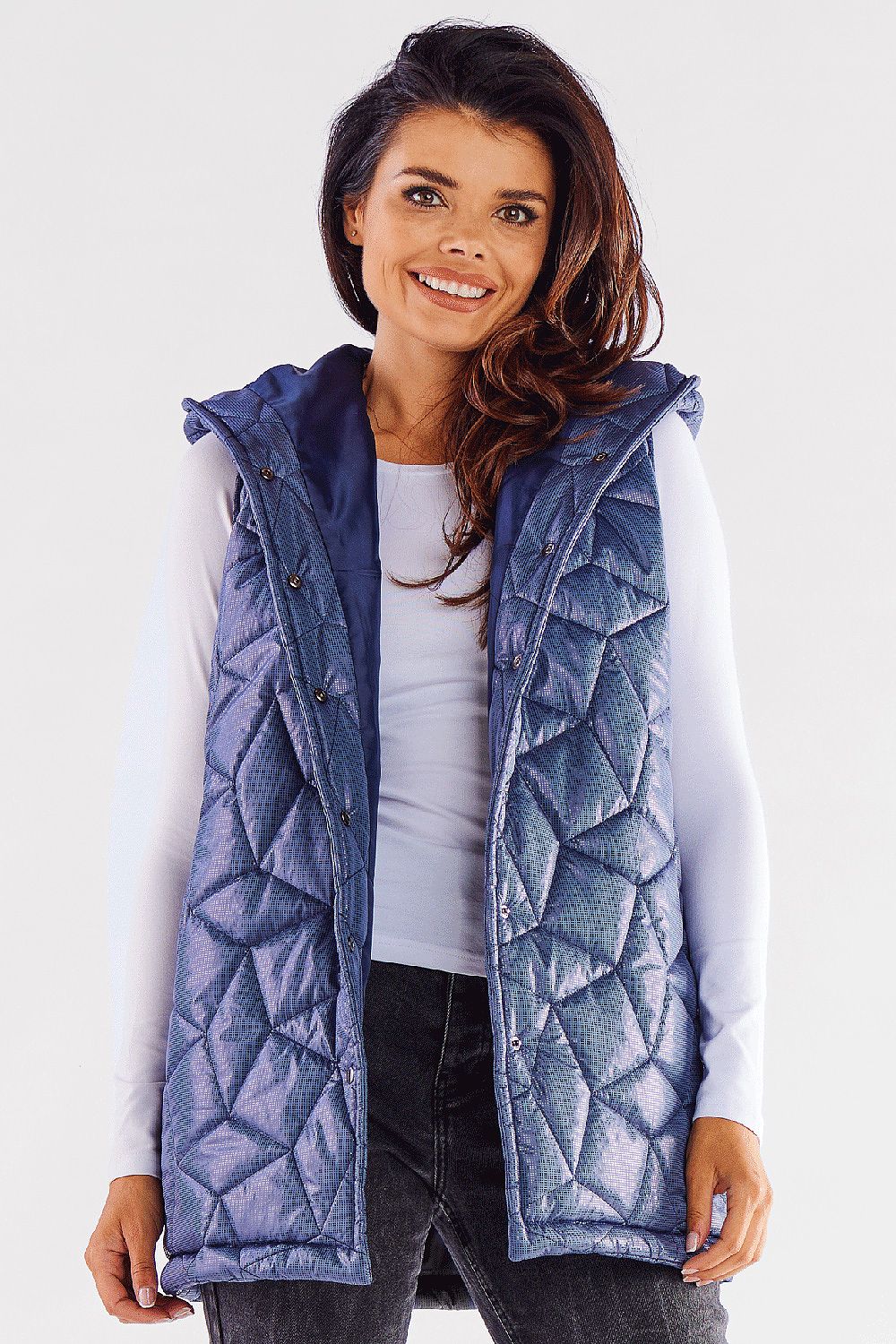 Stunning quilted hooded vest in navy blue, showcased by a smiling model. Perfectly tailored for a luxurious autumn look, this versatile vest adds elegance to any outfit. Ideal for layering in cooler weather, crafted from 100% polyester for warmth and style.