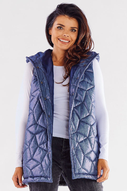 Stunning quilted hooded vest in navy blue, showcased by a smiling model. Perfectly tailored for a luxurious autumn look, this versatile vest adds elegance to any outfit. Ideal for layering in cooler weather, crafted from 100% polyester for warmth and style.
