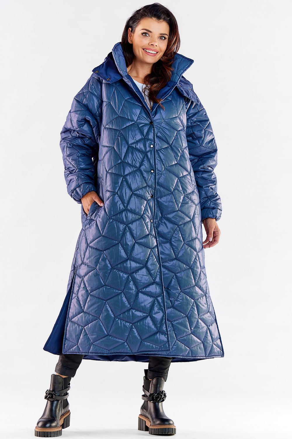 Sophisticated blue long quilted coat with hood and ribbed sleeves, showcasing a knee slit for enhanced mobility, designed for modern luxury wear.