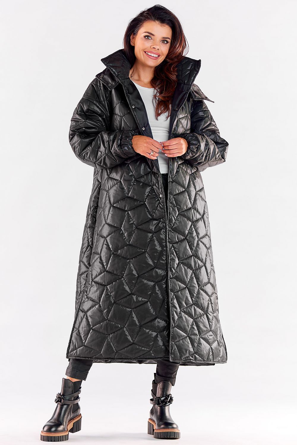 Stylish luxury long quilted coat in black with a hood, designed for ultimate comfort and elegance, featuring ribbed sleeves and a flattering knee slit.