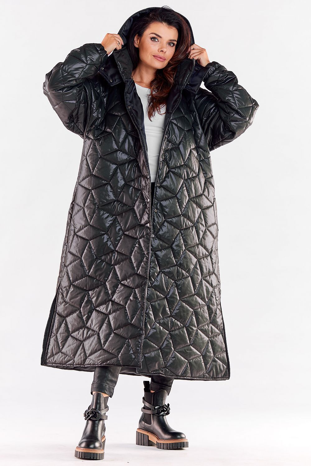 Luxury long quilted hooded coat featuring ribbed sleeves and a stylish knee slit, perfect for effortless movement and contemporary fashion.