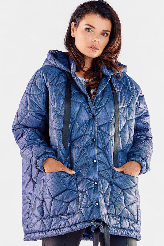 Elegant woman showcasing a luxury oversized quilted jacket with adjustable hood and front pockets, featuring a stylish blue design, perfect for stylish winter wear.