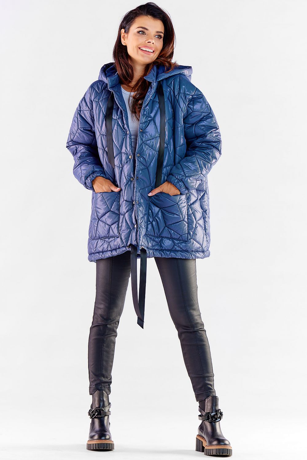 Chic model wearing a luxurious oversized quilted jacket in blue, demonstrating its comfortable fit and fashionable appeal, ideal for contemporary fashion lovers.