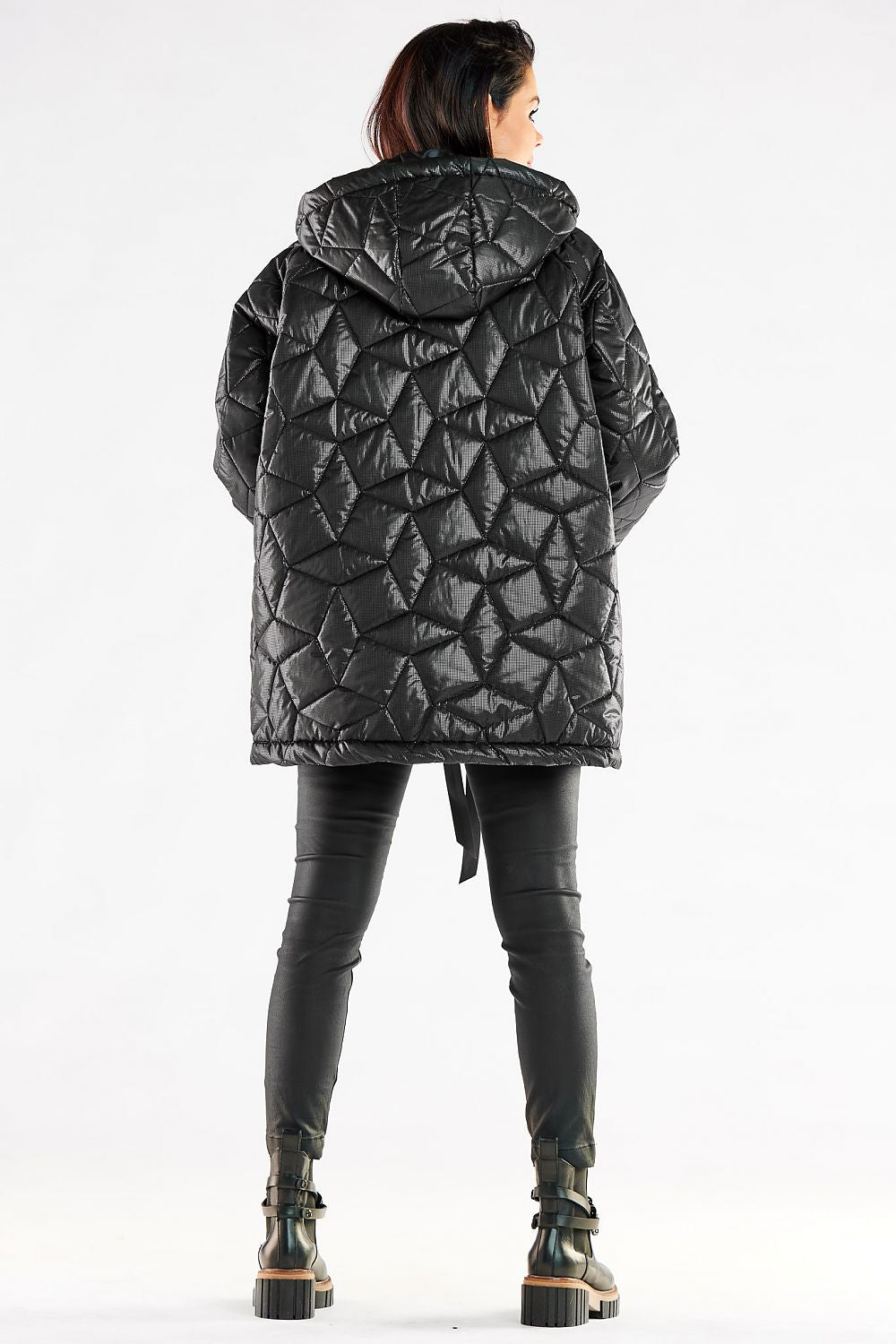Back view of a luxurious oversized quilted jacket with hood worn by a stylish woman, emphasizing the modern quilted design, ideal for fashionable winter attire.