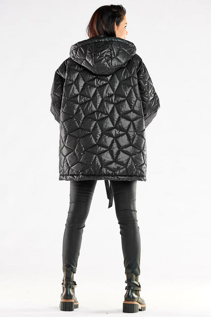 Back view of a luxurious oversized quilted jacket with hood worn by a stylish woman, emphasizing the modern quilted design, ideal for fashionable winter attire.