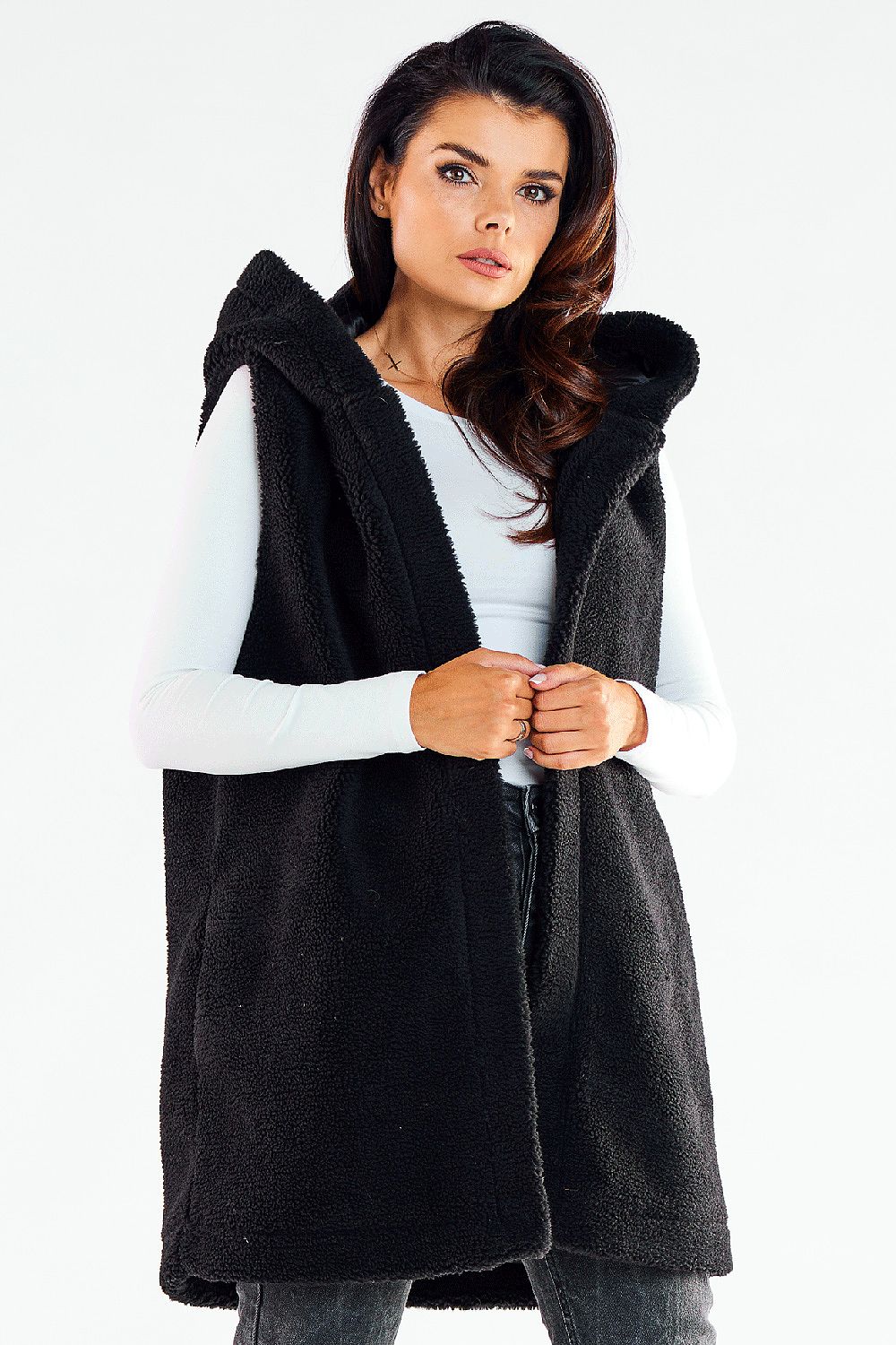 Chic woman wearing an elegant black hooded gilet vest, featuring a luxurious texture and stylish silhouette, perfect for stylish layering on cool days.