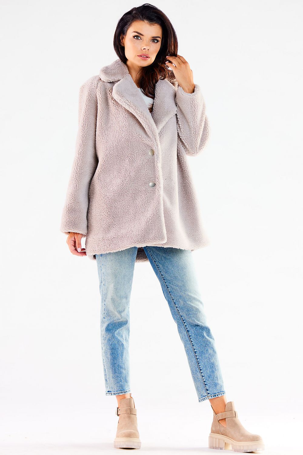 Front view of a fashionable light grey fur coat, displaying a modern silhouette and luxurious fabric, perfectly complemented by blue jeans and fashionable beige ankle boots.