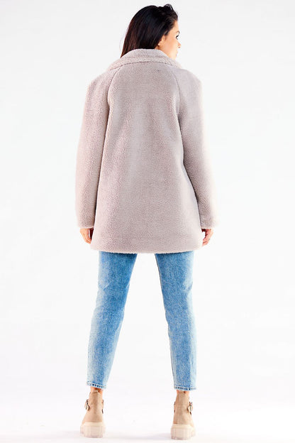 Back view of a lavish light grey women's fur coat, highlighting its exquisite design and comfortable fit, ideal for a stylish winter look paired with denim.