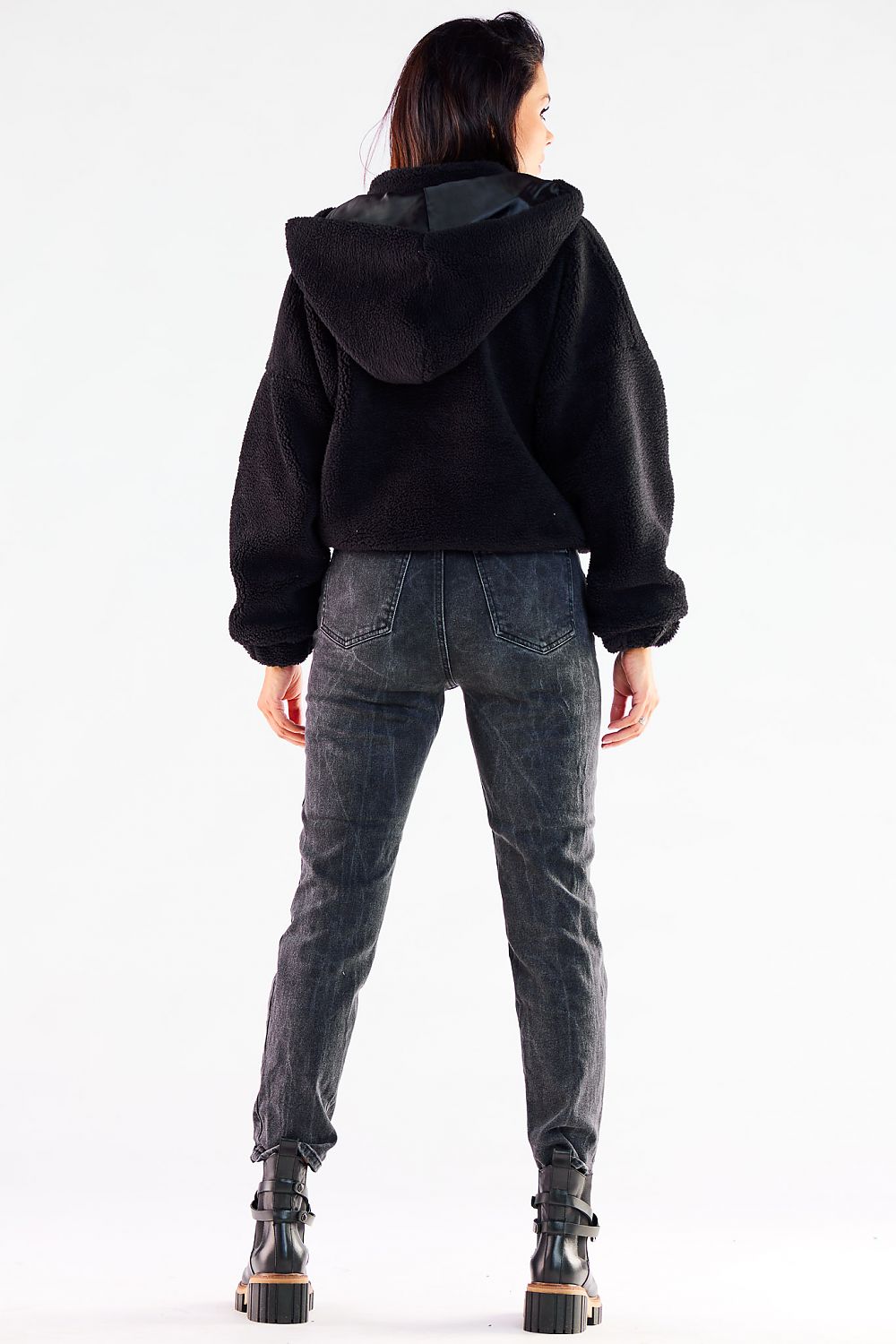 Elegant black zippered hooded jacket, showcasing a contemporary design with ribbed hem, perfect for autumn styling.