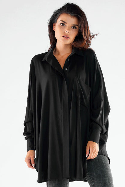 Fashionable women's oversized shirt in classic black, elegantly styled with grey jeans, offering a chic and contemporary look for any occasion.