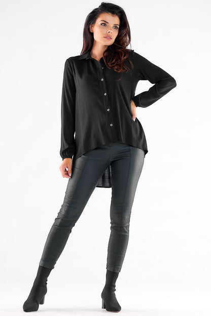 Chic black long sleeve shirt featuring a sophisticated extended back, showcased with imitation leather pants for a trendy urban look.
