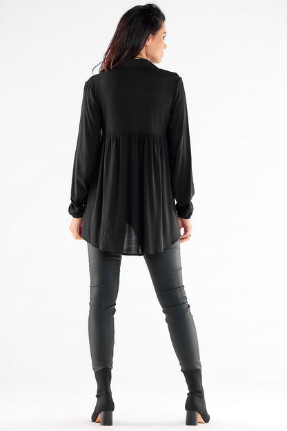 Refined black long sleeve shirt with a flowing back design, creating an effortlessly stylish silhouette, matched with sleek imitation leather pants.