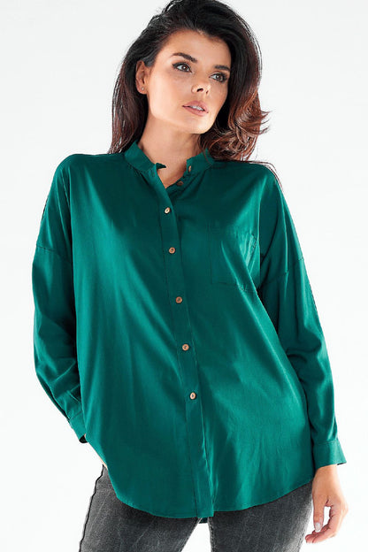 Sophisticated model in a lush green long sleeve buttoned shirt, featuring a stand-up collar and extended back design, showcased by Awama.