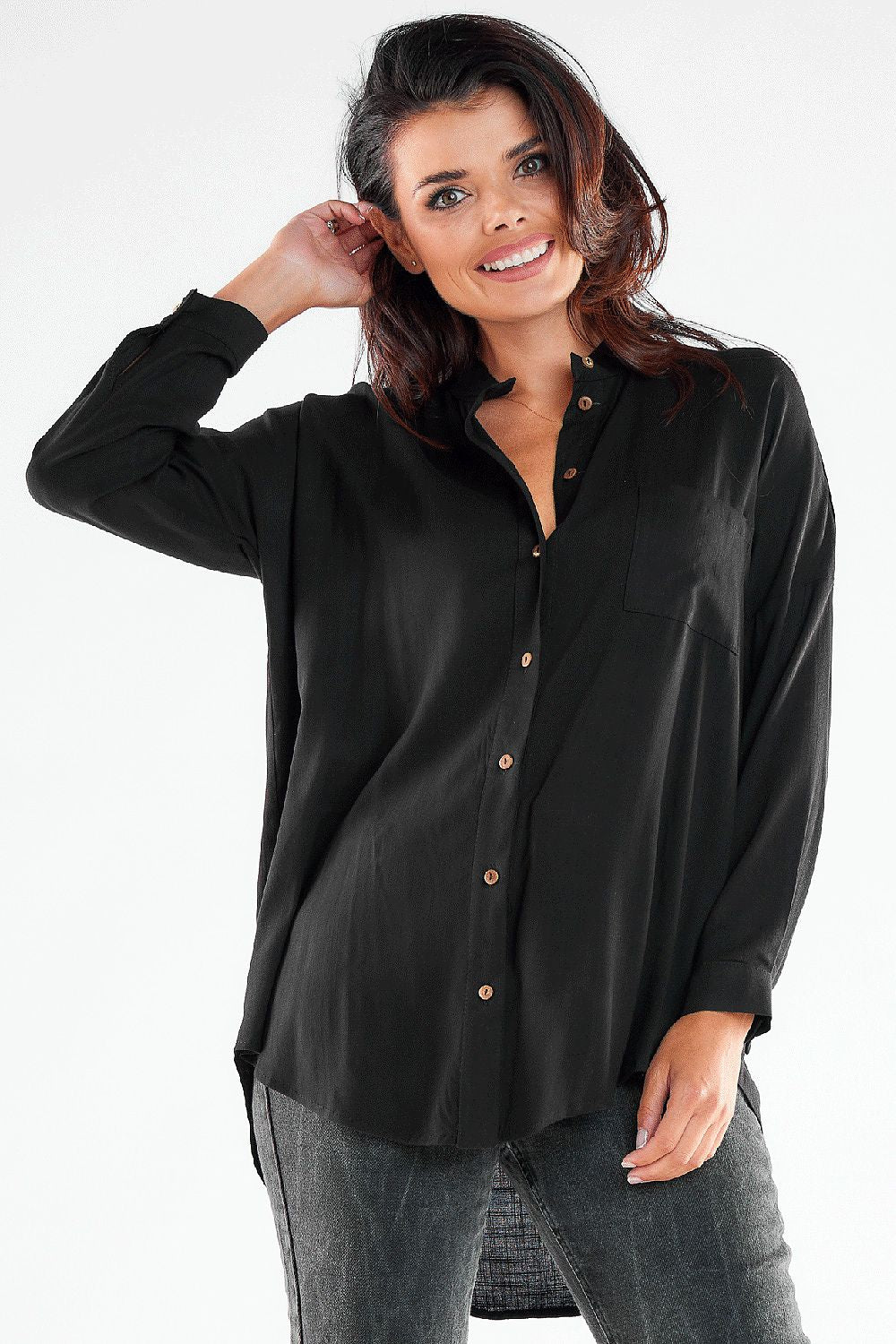 Luxurious black long sleeve buttoned shirt with an extended back, model showcasing an elegant and sophisticated look.