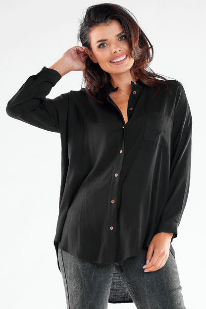 Luxurious black long sleeve buttoned shirt with an extended back, model showcasing an elegant and sophisticated look.
