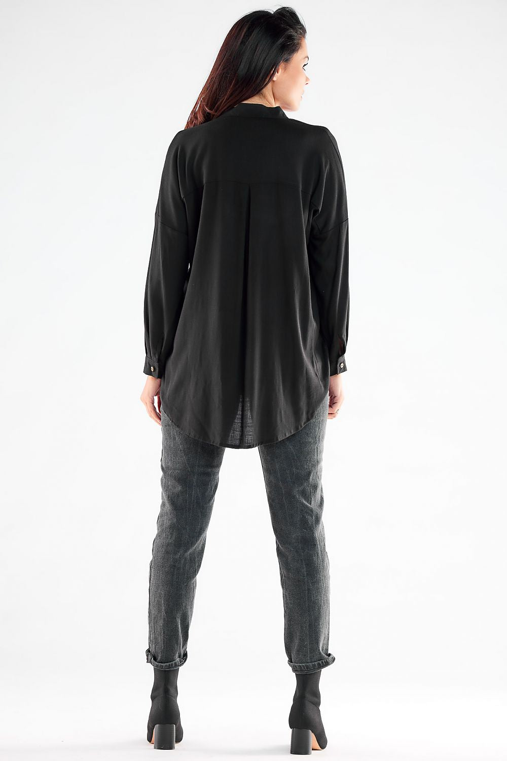 Elegant back view of a black long sleeve buttoned shirt, highlighting its refined design and flowing silhouette.