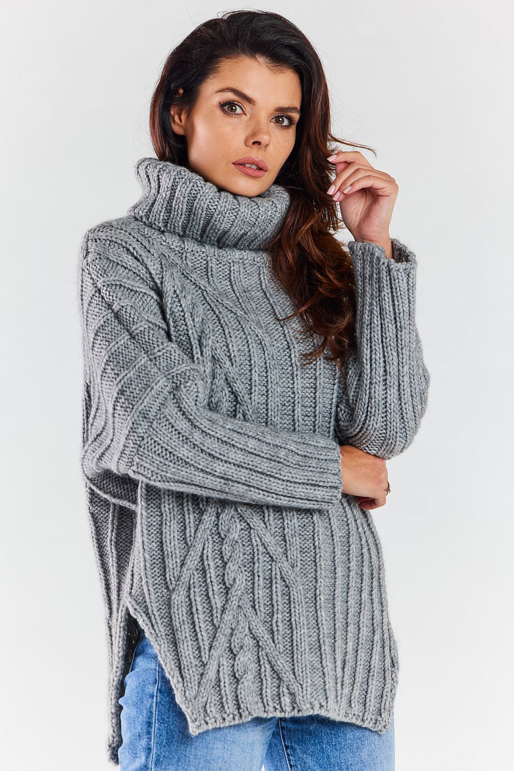 Elegant grey luxury women's turtleneck sweater featuring decorative plaid design, side slits, and ribbed detailing, styled with relaxed denim.