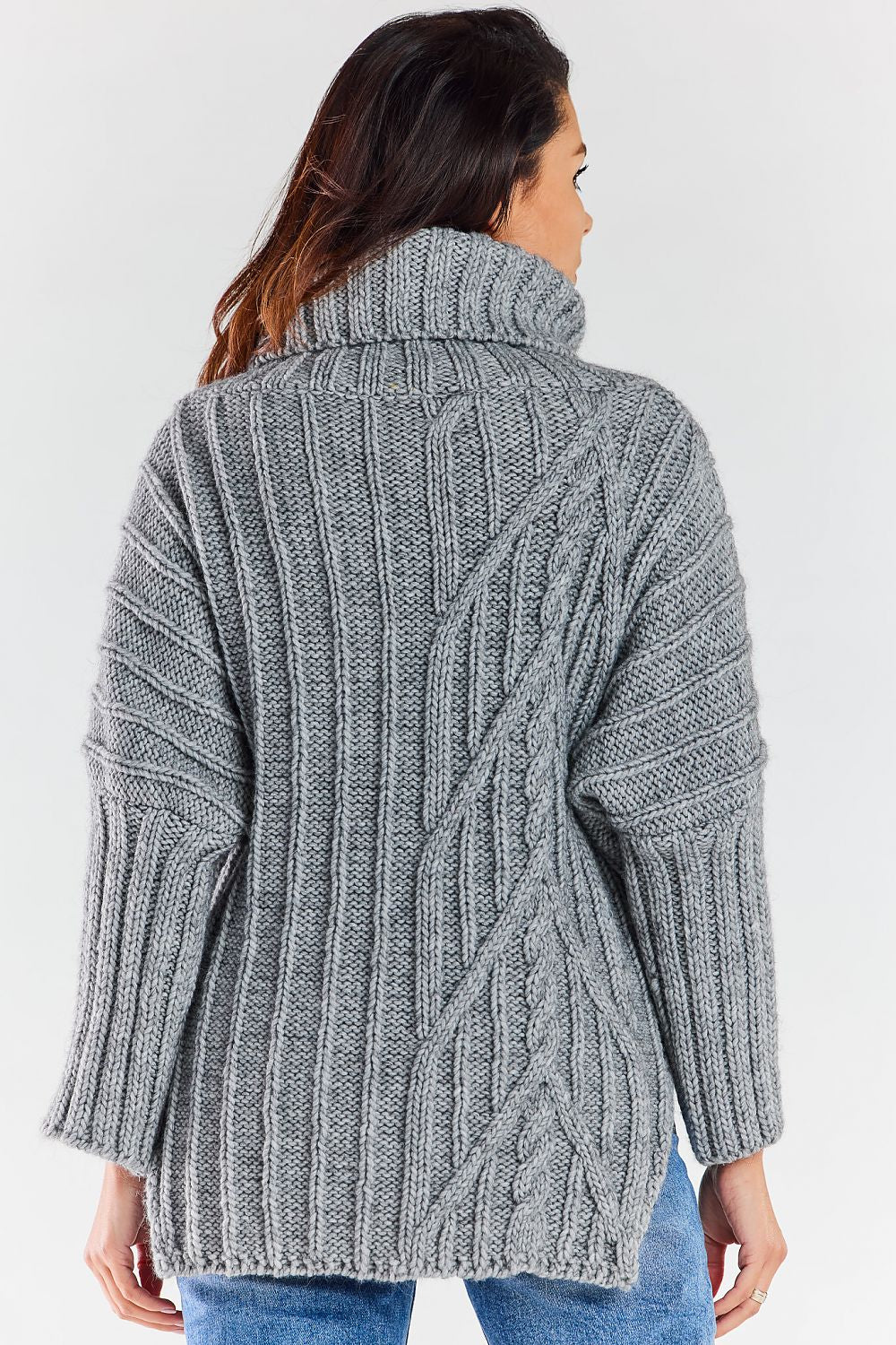 Rear view of a stylish grey luxury women's turtleneck sweater showcasing intricate cable knit patterns and side slits, perfect for a sophisticated winter look.