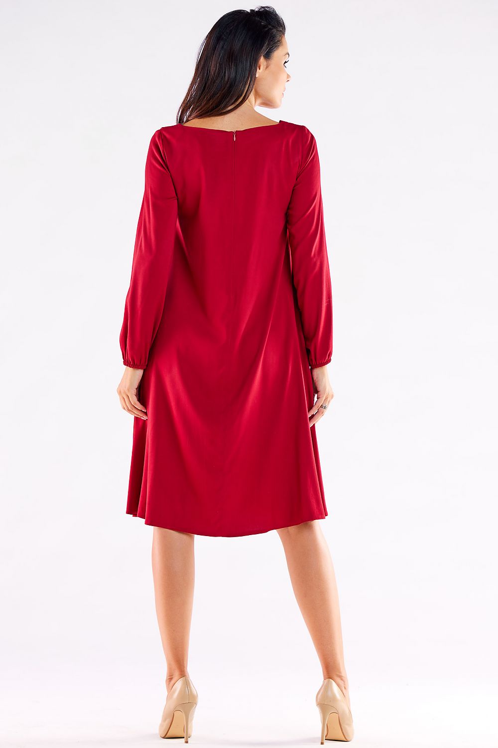 Back view of the elegant women's trapezoidal daydress in deep red, showcasing the graceful cut and subtle detailing at the neckline.