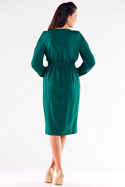 Back view of a stunning green long-sleeved Awama cocktail dress, designed with a relaxed elasticated waist for a flattering silhouette, ideal for formal events.