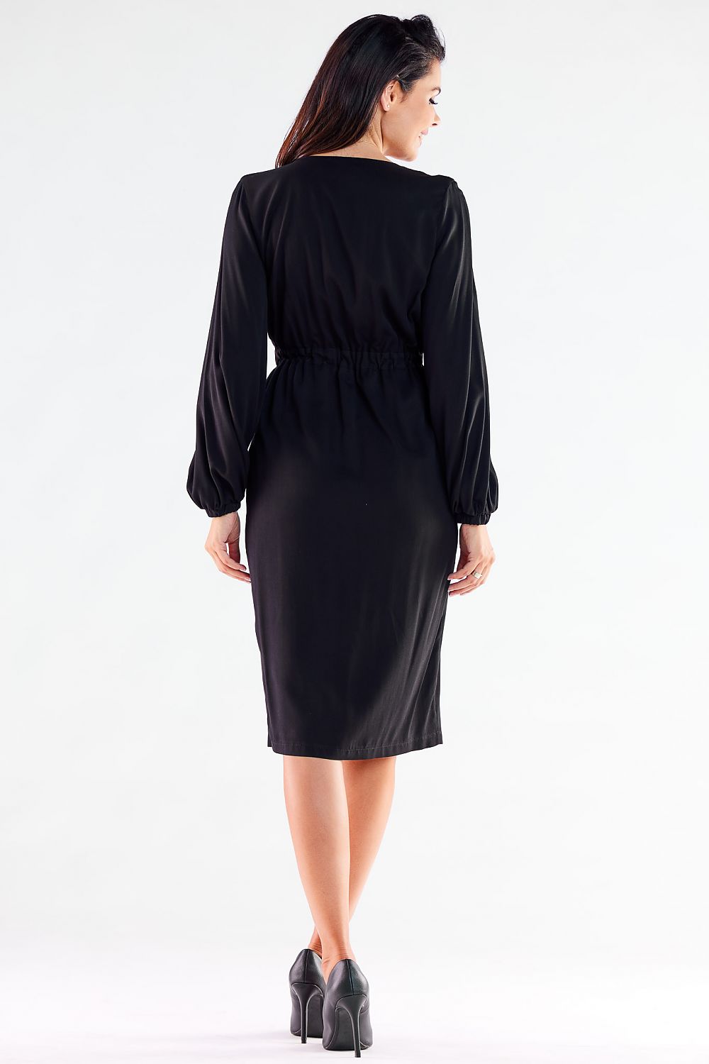 Elegant long-sleeved black cocktail dress from Awama showcasing a sensual slit and V neckline, designed for a sophisticated look perfect for evening events.