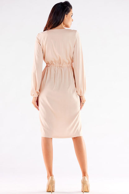 Graceful blush pink cocktail dress with a cinched waist and long sleeves, featuring a stylish slit, perfect for adding a touch of luxury to any formal ensemble.